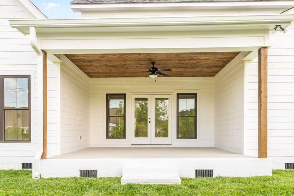 A west facing covered porch will be cooler than a south facing porch
